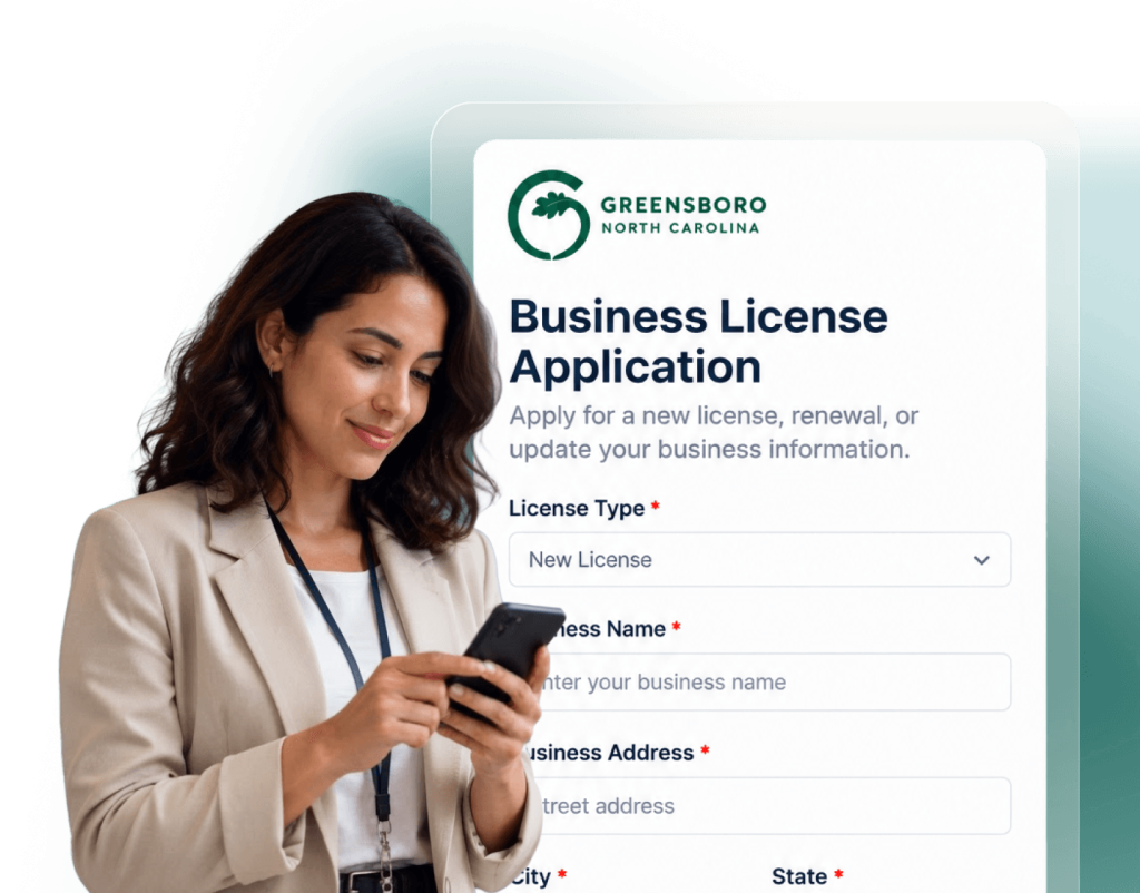 City of Greensboro business license application form with a resident using a phone