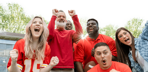 Sports fans cheering at an outdoor football event