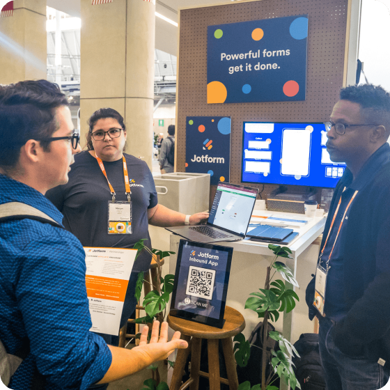 Jotform team speaking with visitors at booth 47